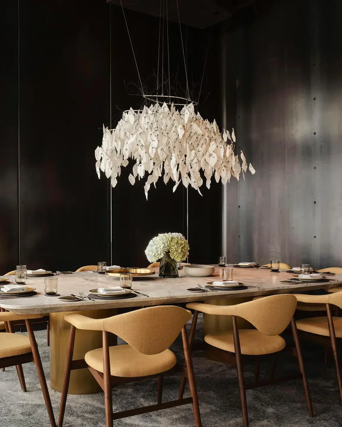 Elegant dining room interior at Woodcut Sydney with unique chandelier and table setting.