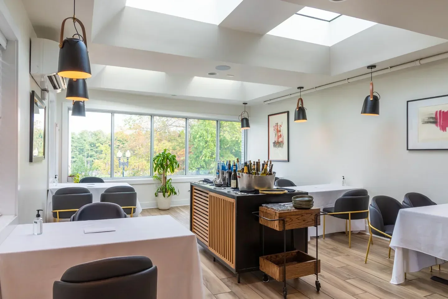 Interior of Xiquet by Danny Lledó in Washington, with tables, bar cart, and lights.