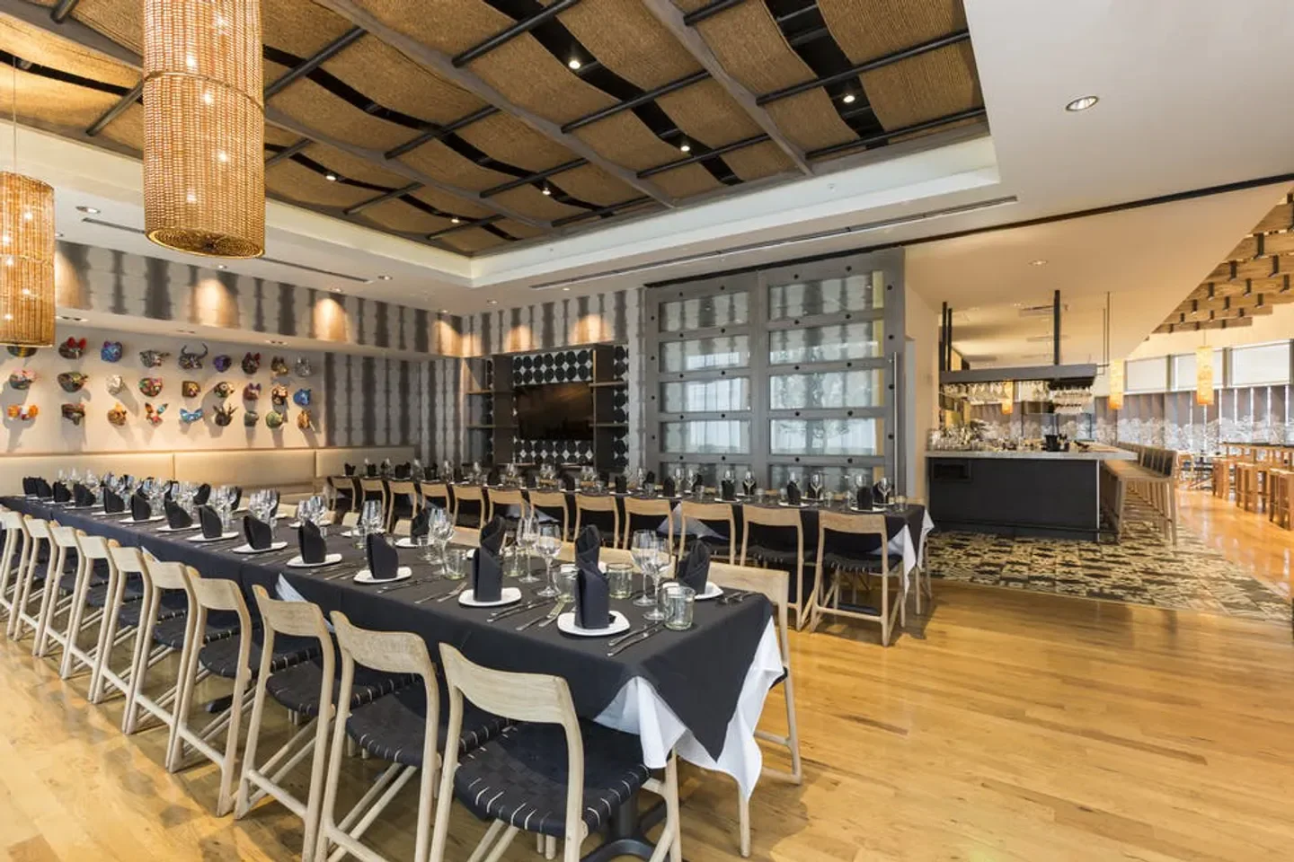 Elegant dining room at Xochi restaurant in Houston, with a long table setting.