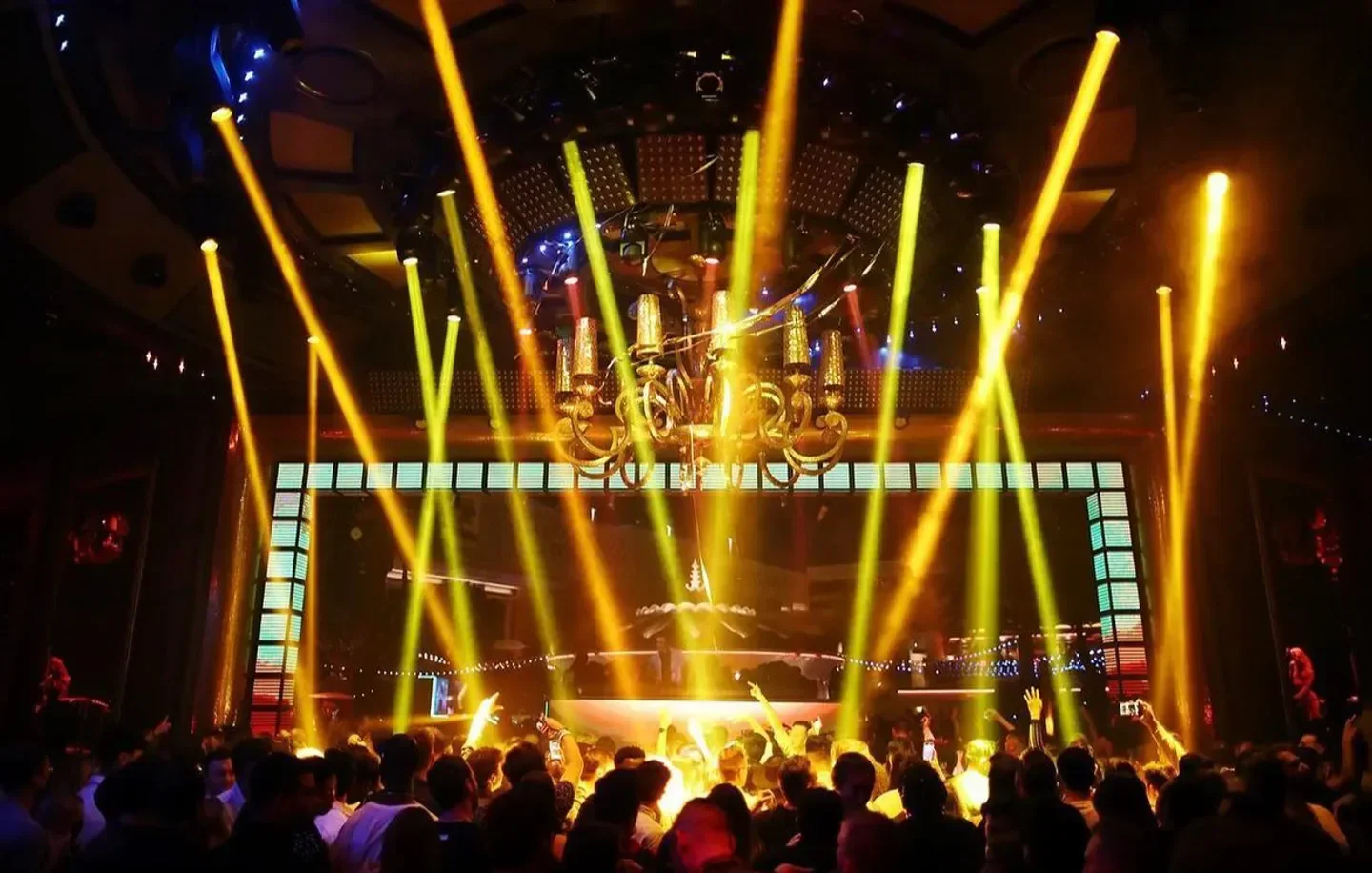 Energetic dance floor at XS nightclub in Las Vegas with vibrant lighting and crowd.