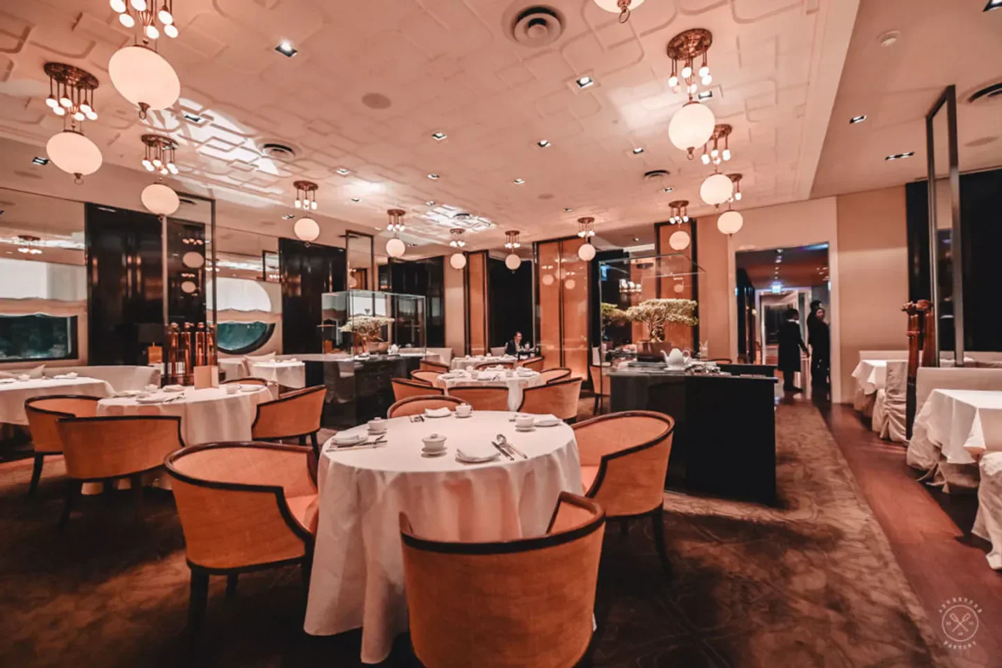 Elegant dining room at Ya Ge restaurant in Taipei, featuring stylish seating and lighting.
