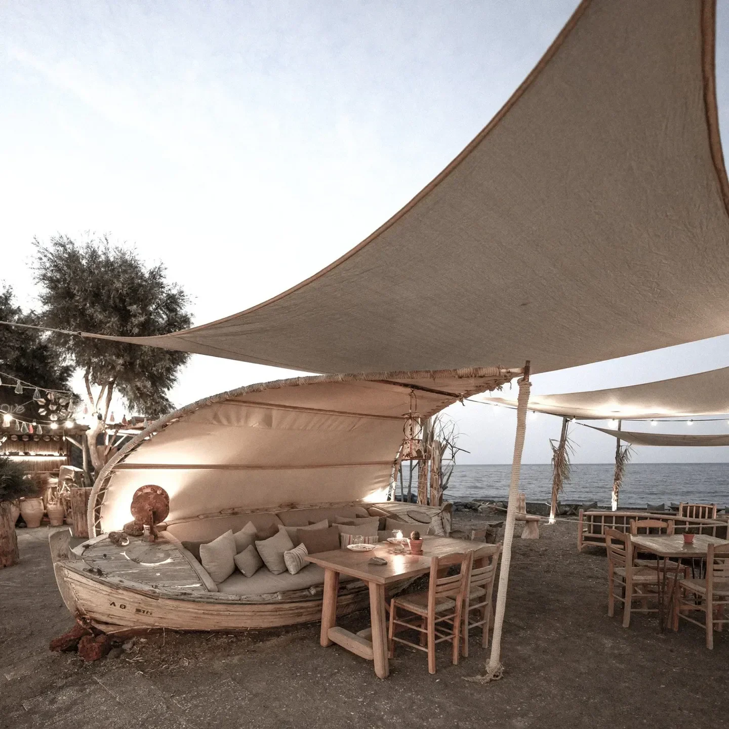 Yalos restaurant in Santorini: Unique boat seating with sea views, a perfect dining spot.