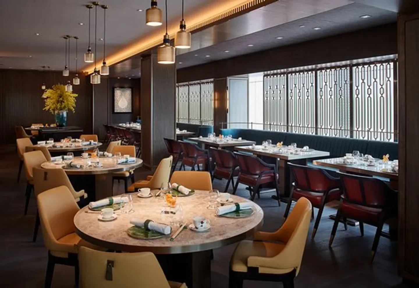 Elegant dining room at Ying Jee Club in Hong Kong with stylish tables and chairs.