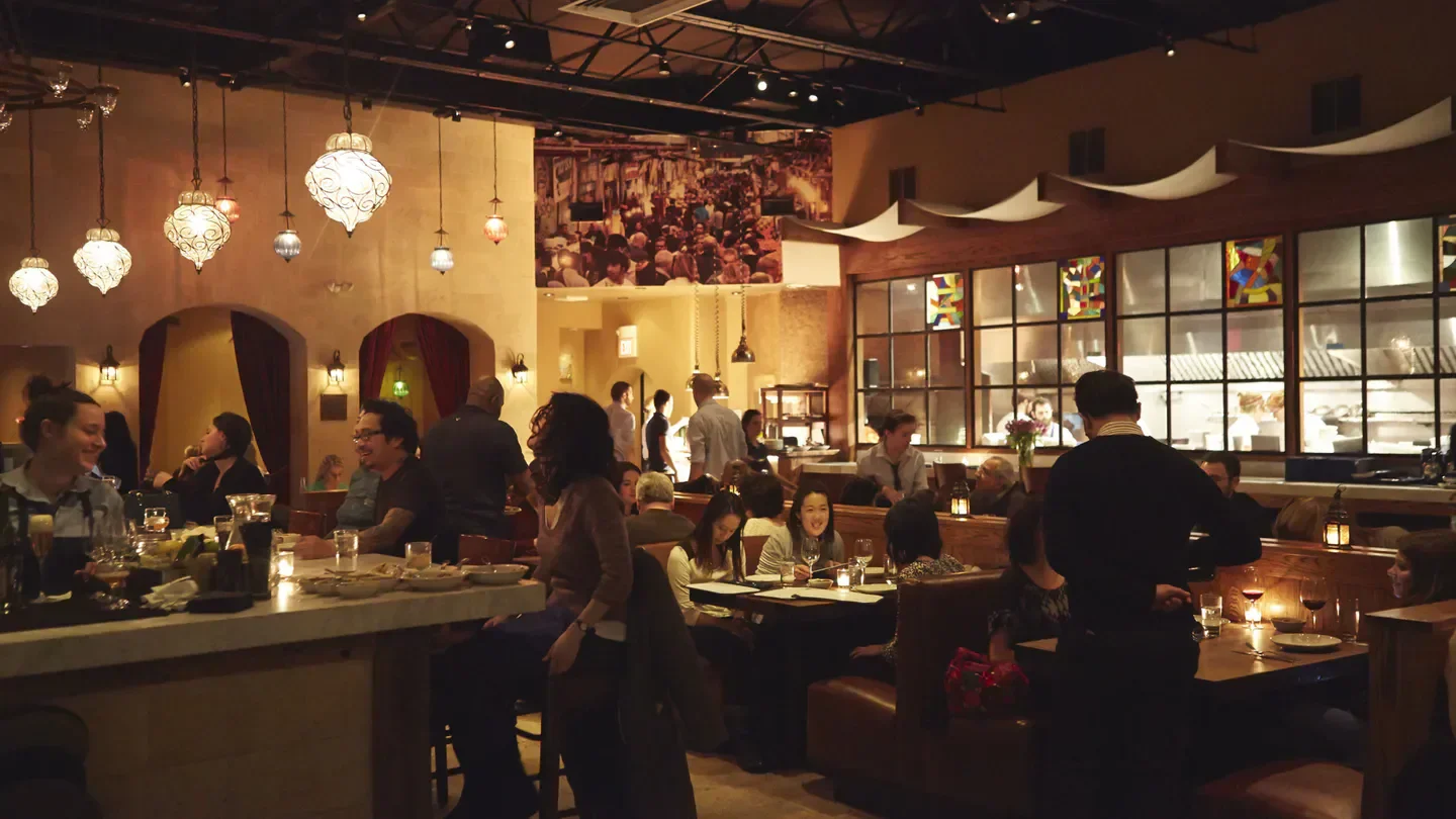 Interior of Zahav in Philadelphia, with warm lighting and a lively atmosphere.