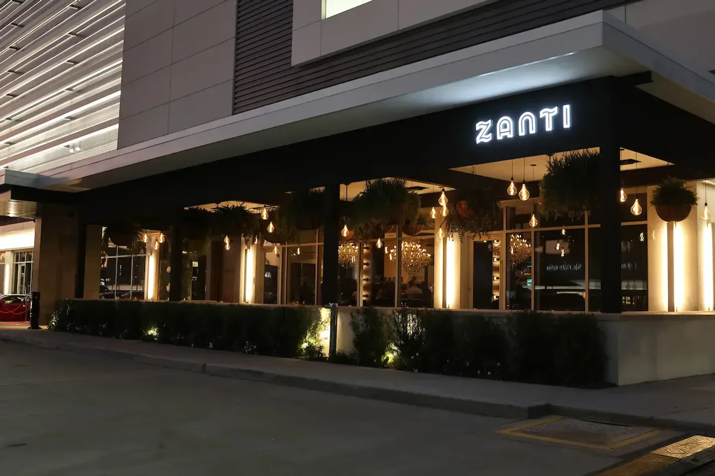 Exterior view of Zanti Cucina Italiana in Houston at night with inviting ambiance