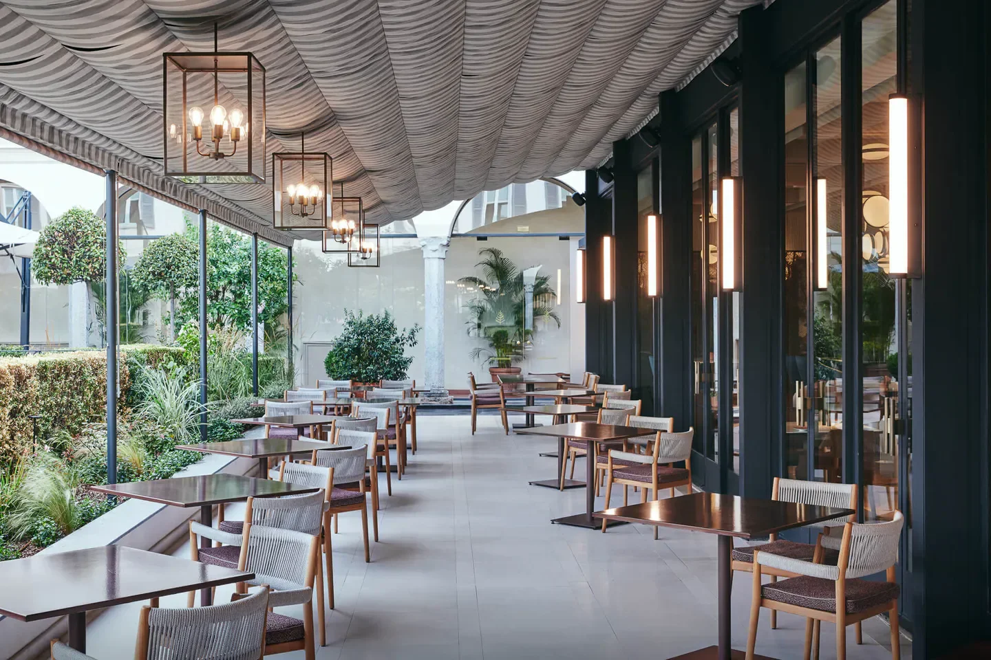 Outdoor seating at ZELO restaurant in Milan, featuring stylish decor and lighting.