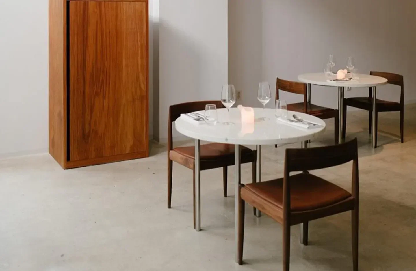 Minimalist interior of Zero Complex restaurant in Seoul, featuring tables and wooden furniture