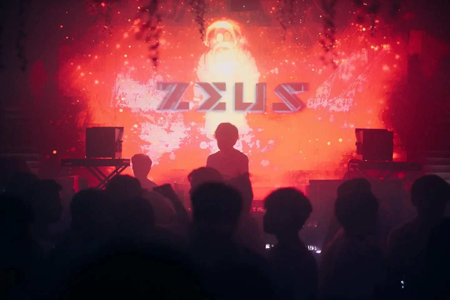 Zeus nightclub in Hong Kong with a dramatic red backdrop and crowd.