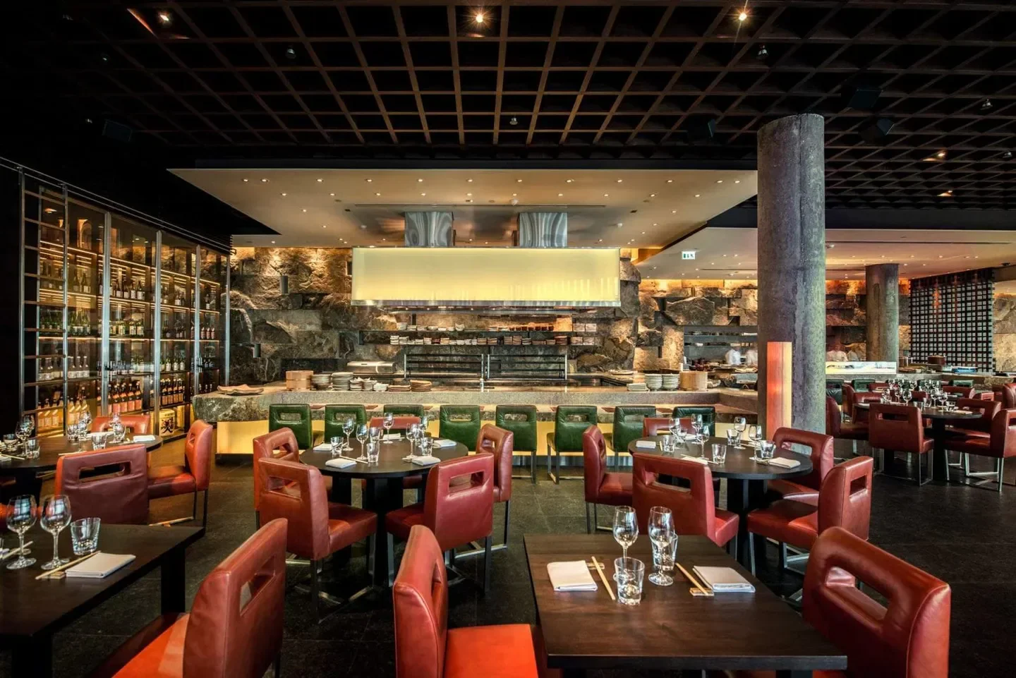 Interior dining space at Zuma Abu Dhabi restaurant in Abu Dhabi with table settings.