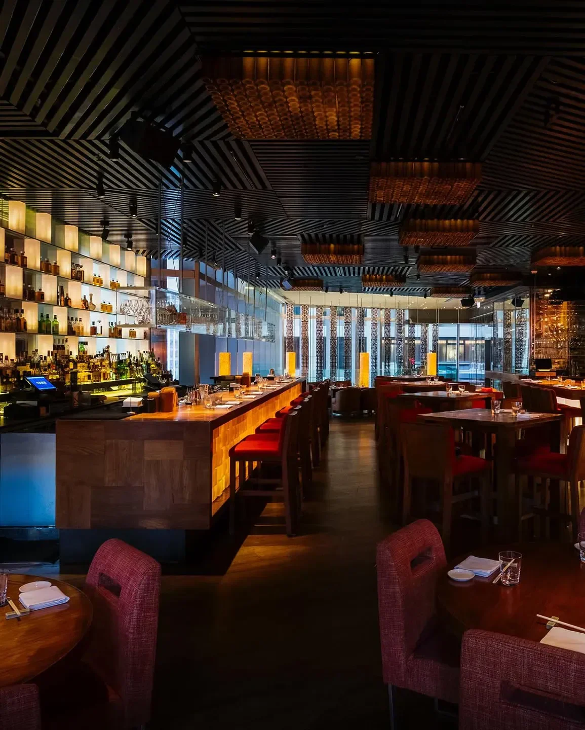 Stylish interior of Zuma restaurant in Hong Kong, featuring bar and dining area.